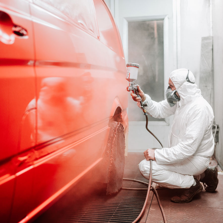 Applying paint to a car with an air brush