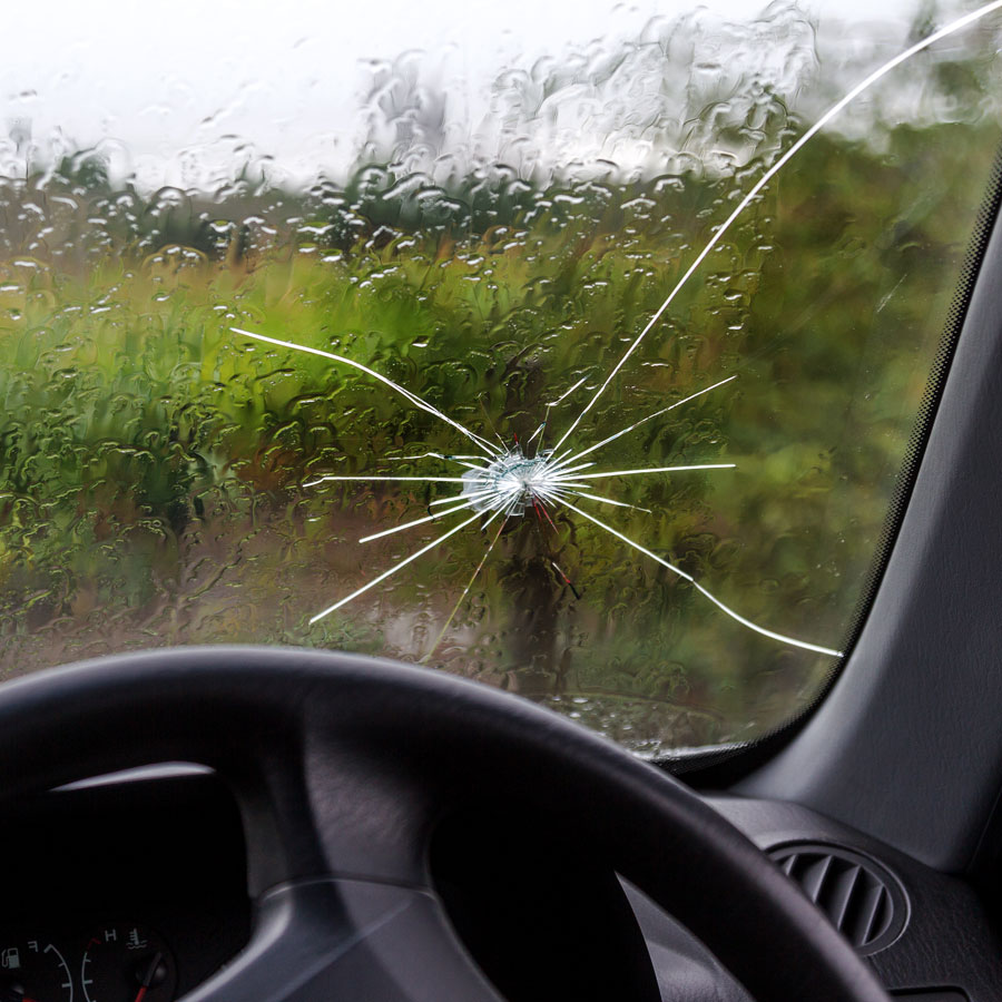 Car windshield with large crack in glass